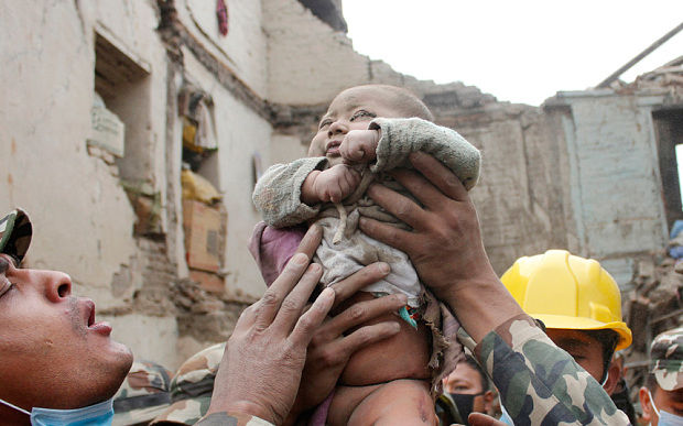 In the aftermath of the Nepal earthquake, a baby is rescued from the rubble